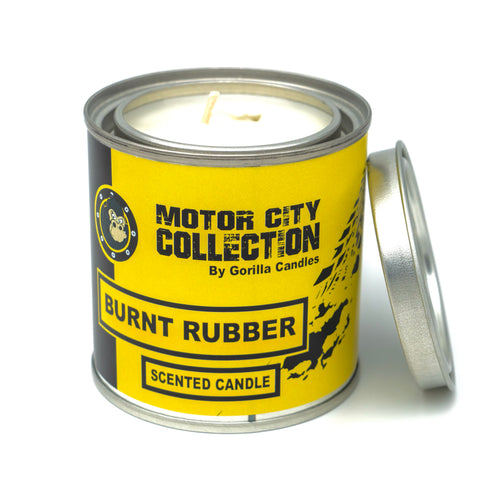 Burnt Rubber candle in a metal tin with a yellow label.