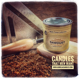 Sawdust Candle sitting on cut wood next to wood shavings and tools.
