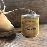 Work Boots candle next to a pair of work boots.