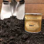 Dirt candle sitting in a pile of dirt with a shovel in the background