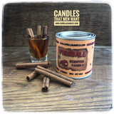  Front view of Fireball Gorilla Candle next to a Fireball shot and cinnamon sticks