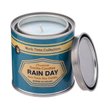 Opened Rain Day candle with blue label around metal tin container